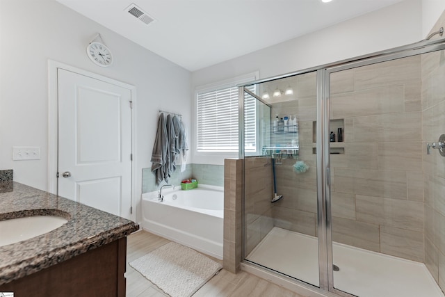 647 Fern Hollow Trl, Anderson, SC 29621 - bathroom with a garden tub, a stall shower, vanity, and wood finished floors