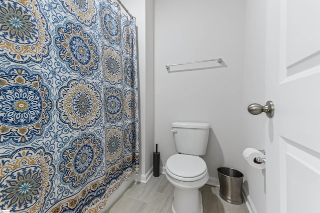 647 Fern Hollow Trl, Anderson, SC 29621 - bathroom featuring toilet, curtained shower, and baseboards