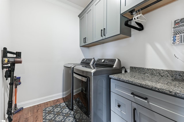 647 Fern Hollow Trl, Anderson, SC 29621 - washroom with cabinet space, washing machine and dryer, dark wood-style flooring, ornamental molding, and baseboards