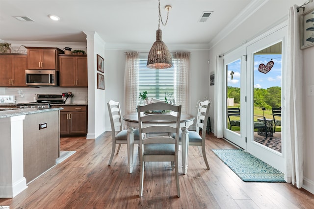 647 Fern Hollow Trl, Anderson, SC 29621 - dining space featuring light wood-type flooring, crown molding, and baseboards