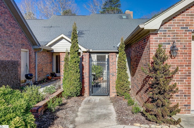 409 Hunters Cir, Greenville, SC 29617 - property entrance featuring brick siding, a chimney, and a shingled roof