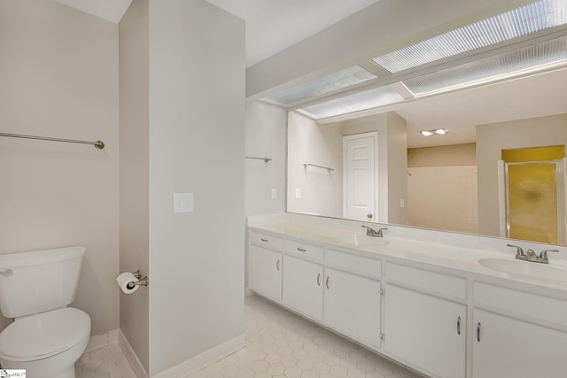 409 Hunters Cir, Greenville, SC 29617 - full bathroom featuring toilet, double vanity, a shower with shower door, tile patterned flooring, and baseboards
