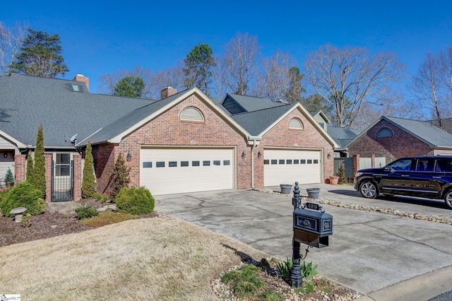 409 Hunters Cir, Greenville, SC 29617 - view of front of home with brick siding, a garage, concrete driveway, and a chimney