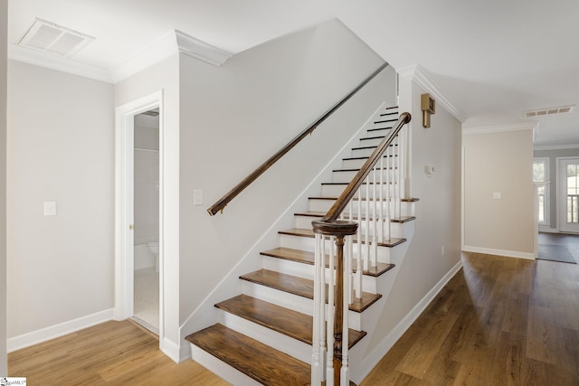 409 Hunters Cir, Greenville, SC 29617 - stairs featuring wood finished floors, crown molding, and baseboards