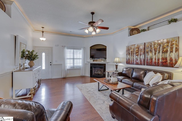 809 Dove Creek Ct, Boiling Springs, SC 29316 - living room featuring ornamental molding, ceiling fan, dark wood-type flooring, a fireplace, and a textured ceiling