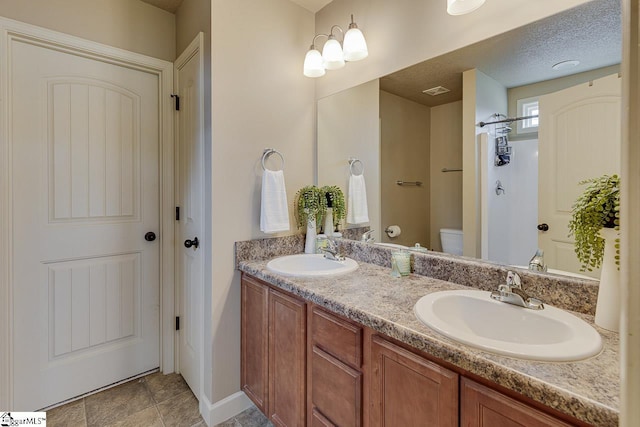 809 Dove Creek Ct, Boiling Springs, SC 29316 - bathroom with toilet, double vanity, a shower, and baseboards