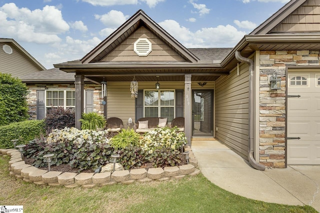 809 Dove Creek Ct, Boiling Springs, SC 29316 - property entrance featuring stone siding, a porch, a garage, and roof with shingles