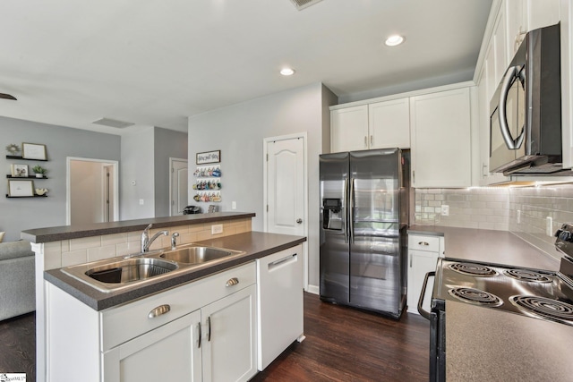 413 Basalt Ct, Powdersville, SC 29642 - kitchen featuring appliances with stainless steel finishes, a sink, decorative backsplash, dark countertops, and a kitchen island with sink