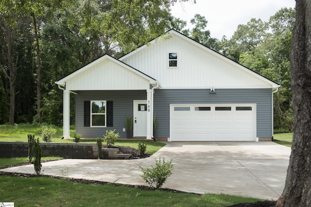 168 Dunbar St, Wellford, SC 29385 - modern farmhouse style home with an attached garage, driveway, and a porch