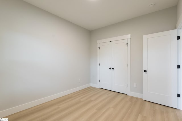 168 Dunbar St, Wellford, SC 29385 - unfurnished bedroom with light wood-style flooring, baseboards, and a closet