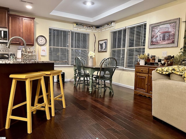 20 Hawkcrest Ct, Travelers Rest, SC 29690 - dining space featuring a raised ceiling, dark wood-style flooring, baseboards, and recessed lighting