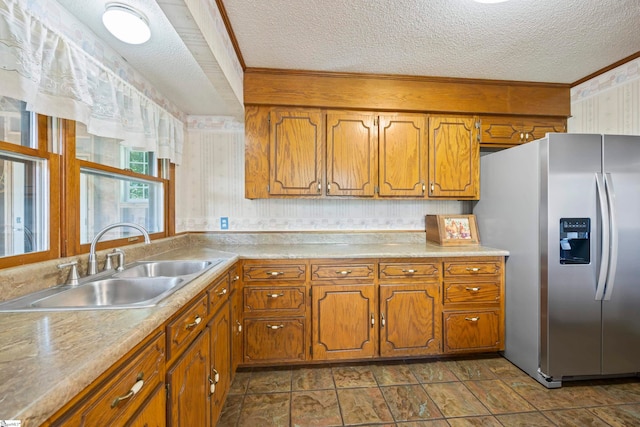 280 Kari Dr, Westminster, SC 29693 - kitchen with stainless steel fridge, a sink, a textured ceiling, brown cabinetry, and light countertops