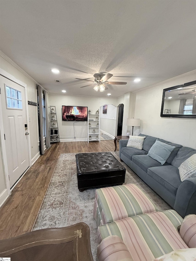 405 Perry Rd, Greenville, SC 29609 - living room with ceiling fan, arched walkways, wood finished floors, ornamental molding, and a textured ceiling