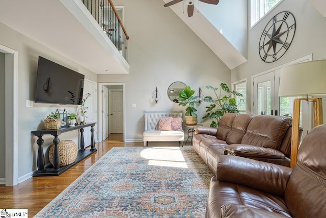 182 Roundstone Dr, Inman, SC 29349 - living room featuring a towering ceiling, a ceiling fan, healthy amount of natural light, wood finished floors, and baseboards