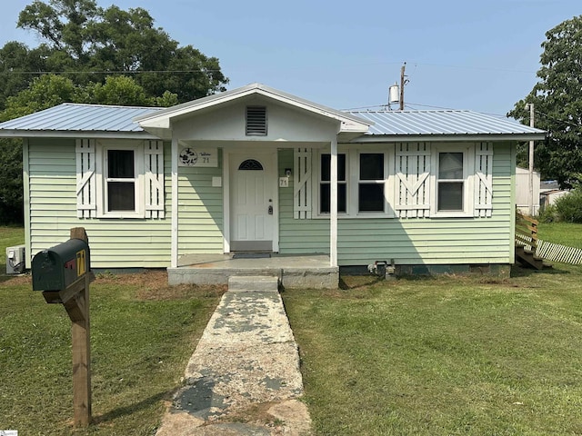 71 2nd St, Laurens, SC 29360 - bungalow-style home featuring covered porch, a front lawn, metal roof, and crawl space