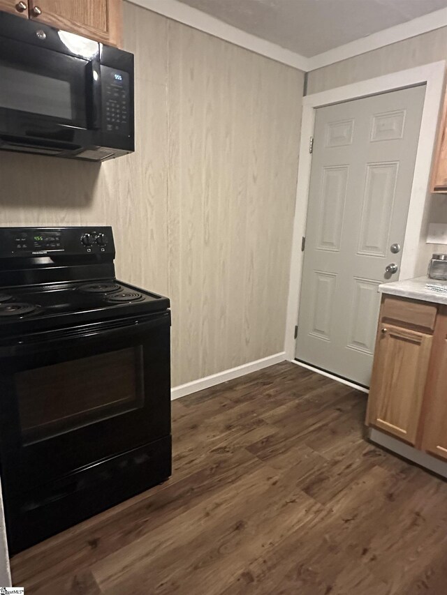 71 2nd St, Laurens, SC 29360 - kitchen with black appliances, dark wood finished floors, light countertops, crown molding, and brown cabinets