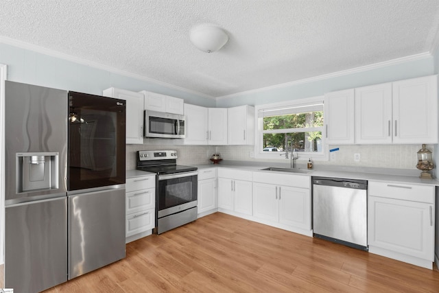 209 Boyd Ave, Simpsonville, SC 29681 - kitchen with appliances with stainless steel finishes, a sink, a textured ceiling, ornamental molding, and decorative backsplash