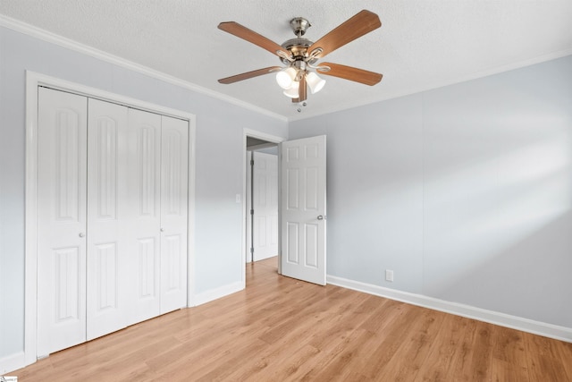 209 Boyd Ave, Simpsonville, SC 29681 - unfurnished bedroom featuring light wood-type flooring, a closet, ornamental molding, baseboards, and a ceiling fan