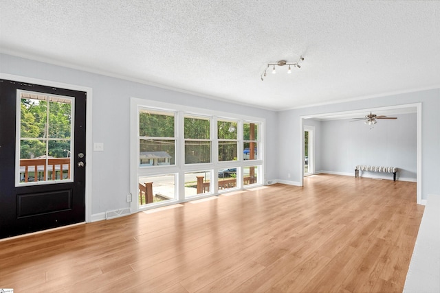 209 Boyd Ave, Simpsonville, SC 29681 - unfurnished living room featuring a textured ceiling, light wood finished floors, and baseboards