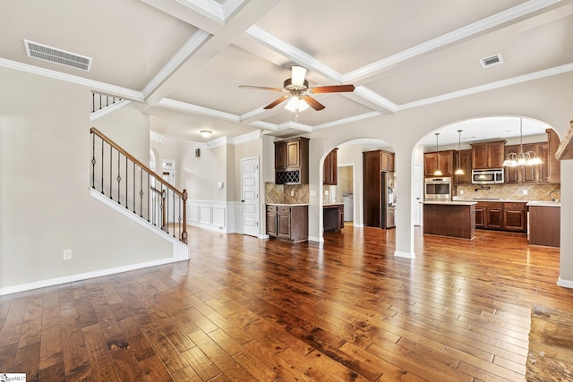 135 Adams Creek Pl, Simpsonville, SC 29681 - unfurnished living room with coffered ceiling, dark wood finished floors, a ceiling fan, arched walkways, and beam ceiling