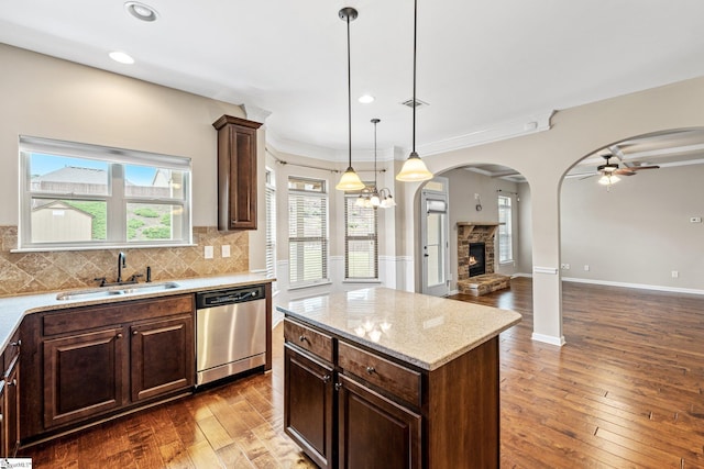 135 Adams Creek Pl, Simpsonville, SC 29681 - kitchen featuring stainless steel dishwasher, a sink, a stone fireplace, open floor plan, and ceiling fan