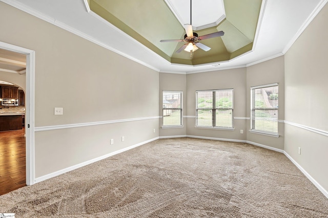 135 Adams Creek Pl, Simpsonville, SC 29681 - empty room with a tray ceiling, arched walkways, a ceiling fan, crown molding, and baseboards