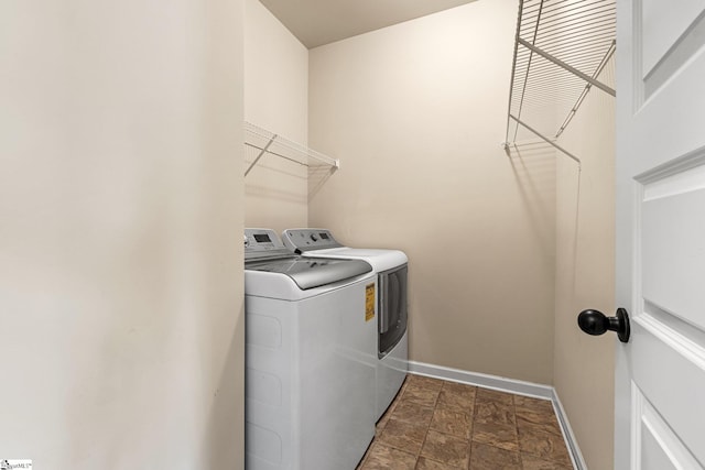 135 Adams Creek Pl, Simpsonville, SC 29681 - laundry room featuring independent washer and dryer, stone finish flooring, and baseboards