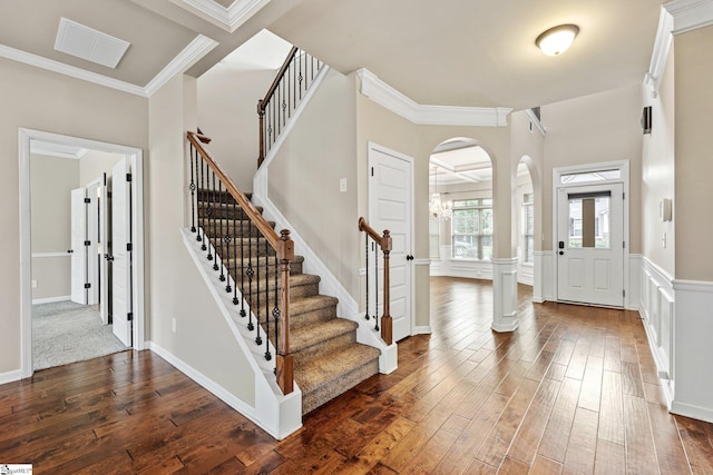 135 Adams Creek Pl, Simpsonville, SC 29681 - entryway with dark wood-type flooring, arched walkways, stairway, and ornamental molding