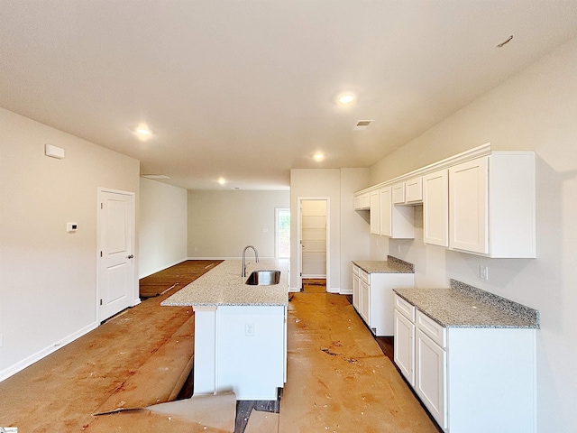 209 Islay Way, Anderson, SC 29621 - kitchen with a sink, white cabinets, a center island with sink, light stone countertops, and recessed lighting