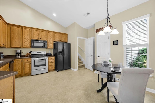 415 Plamondon Dr, Simpsonville, SC 29680 - kitchen with black appliances, dark countertops, brown cabinetry, pendant lighting, and high vaulted ceiling
