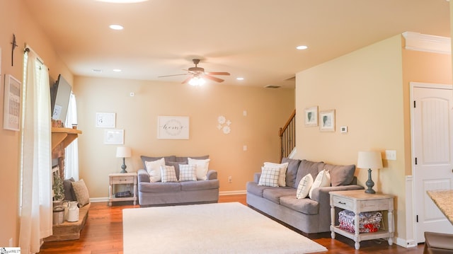 354 Harkins Bluff Dr, Greer, SC 29651 - living room featuring stairs, a ceiling fan, dark wood-style flooring, a fireplace with raised hearth, and recessed lighting