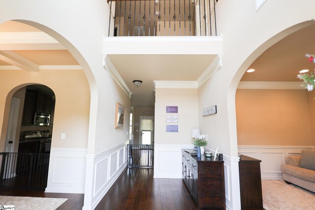 354 Harkins Bluff Dr, Greer, SC 29651 - foyer entrance with dark wood-style flooring, a wainscoted wall, ornamental molding, a decorative wall, and a towering ceiling