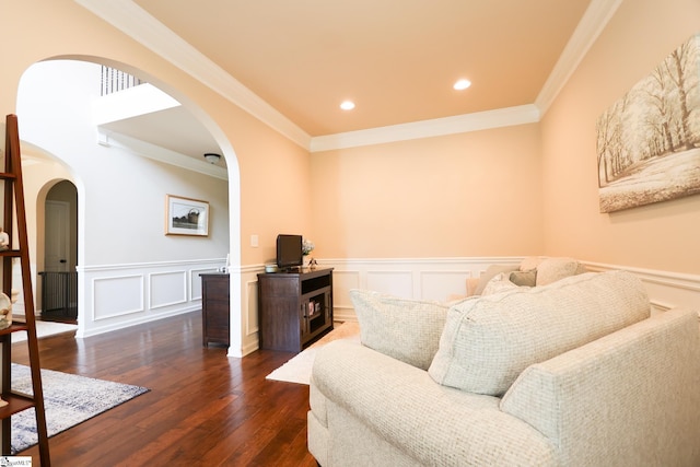 354 Harkins Bluff Dr, Greer, SC 29651 - living room featuring arched walkways, dark wood finished floors, a wainscoted wall, crown molding, and a decorative wall