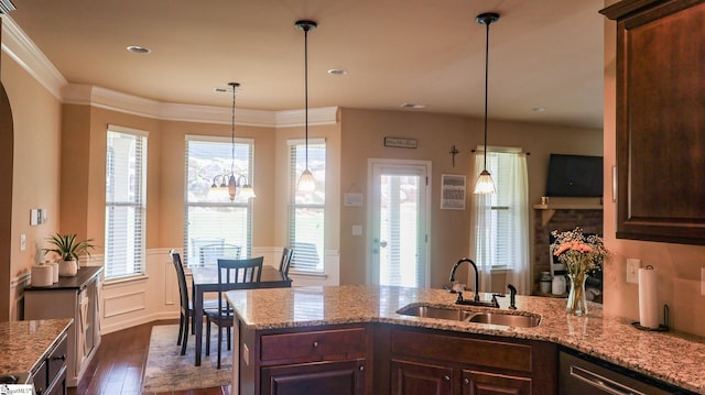 354 Harkins Bluff Dr, Greer, SC 29651 - kitchen with dark wood-style floors, stainless steel dishwasher, dark brown cabinetry, a peninsula, and light stone counters