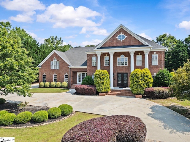 201 Corinthian Dr, Simpsonville, SC 29681 - greek revival inspired property featuring french doors, brick siding, and curved driveway