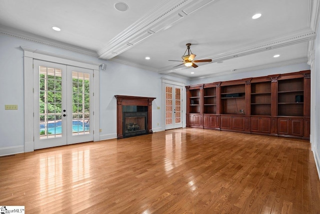 201 Corinthian Dr, Simpsonville, SC 29681 - unfurnished living room featuring french doors, crown molding, a ceiling fan, light wood-style floors, and baseboards