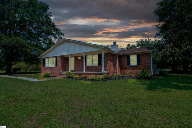 231 E Hampton Ave, Honea Path, SC 29654 - ranch-style home with brick siding, a chimney, a lawn, and a porch