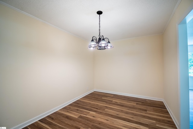 231 E Hampton Ave, Honea Path, SC 29654 - empty room with a chandelier, dark wood-type flooring, ornamental molding, and baseboards