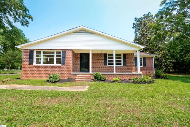 231 E Hampton Ave, Honea Path, SC 29654 - view of front of home with a front lawn, brick siding, and a porch