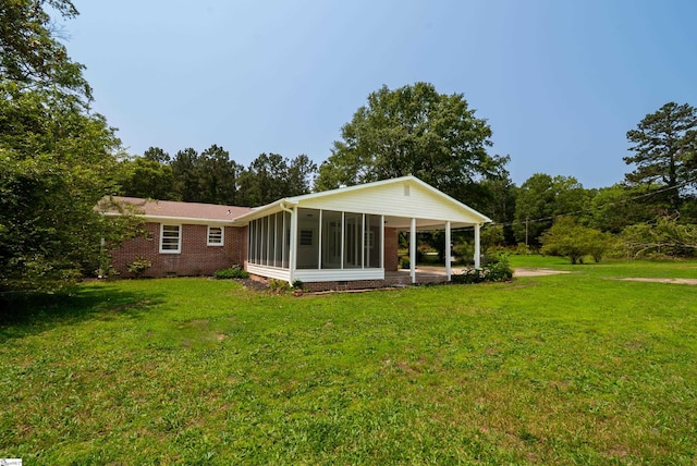 231 E Hampton Ave, Honea Path, SC 29654 - back of property with a sunroom, a lawn, and brick siding