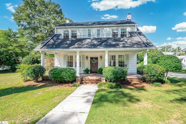 102 Todd Ave, Laurens, SC 29360 - view of front of house featuring a chimney, covered porch, and a front yard