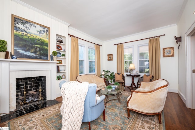 102 Todd Ave, Laurens, SC 29360 - living area with ornamental molding, wood finished floors, built in shelves, a fireplace, and baseboards