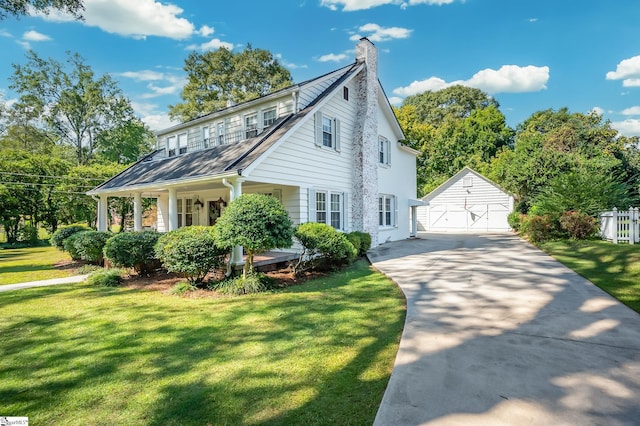 102 Todd Ave, Laurens, SC 29360 - traditional-style home with an outdoor structure, a front lawn, covered porch, a garage, and a chimney