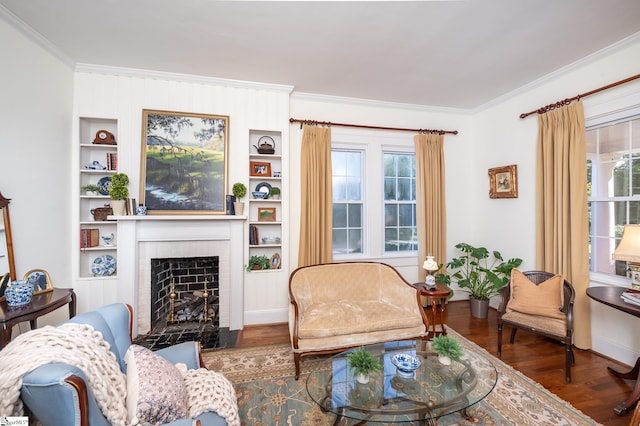 102 Todd Ave, Laurens, SC 29360 - living room with crown molding, wood finished floors, a fireplace with flush hearth, baseboards, and built in features