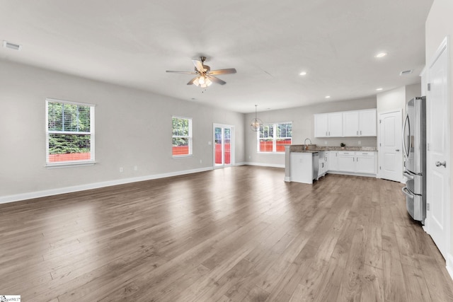 203 Rosewood Cir, Duncan, SC 29334 - unfurnished living room with a ceiling fan, wood finished floors, healthy amount of natural light, recessed lighting, and baseboards