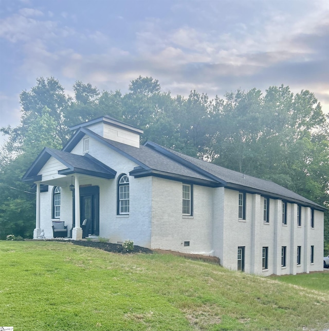 127 Eastview Rd, Pelzer, SC 29669 - view of front facade featuring brick siding, a front yard, a porch, and a shingled roof