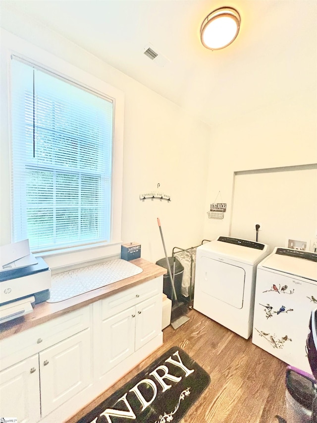 127 Eastview Rd, Pelzer, SC 29669 - laundry room with washer and dryer, light wood-style flooring, and cabinet space