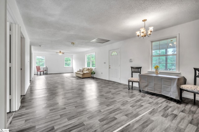 207 Starnes Rd, Laurens, SC 29360 - living room featuring a textured ceiling, plenty of natural light, a chandelier, wood finished floors, and ceiling fan