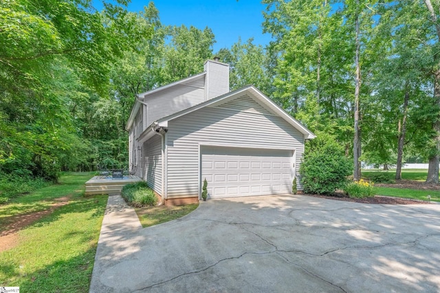 101 Shagbark Cir, Simpsonville, SC 29680 - view of side of property with driveway, a chimney, an attached garage, and a lawn