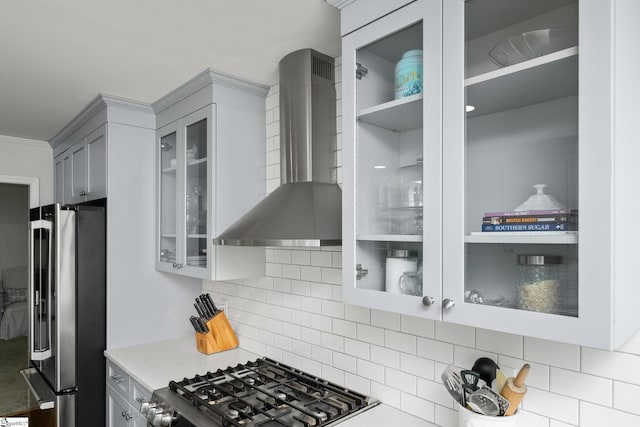 101 Shagbark Cir, Simpsonville, SC 29680 - kitchen with freestanding refrigerator, wall chimney exhaust hood, range, tasteful backsplash, and glass insert cabinets